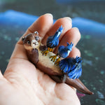 Clawless otter with black herons figurine