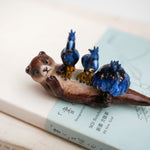 Clawless otter with night herons figurine