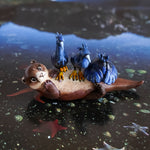 Clawless otter with black herons figurine