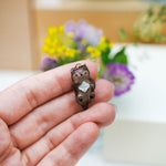 Otter with a mother-of-pearl pendant