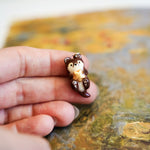 Otter with a gold star pendant