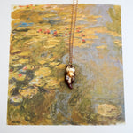 Otter with a gold star pendant