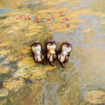 Otter with a silver shell pendant