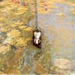 Otter with a silver shell pendant