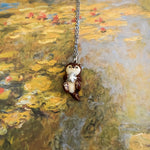 Otter with a silver star pendant