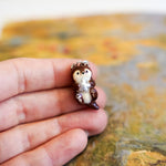 Otter with a silver star pendant