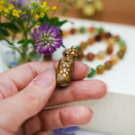 Pallas Cat with a mother-of-pearl pendant