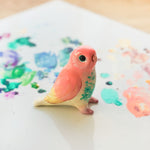 Peach lovebird figurine