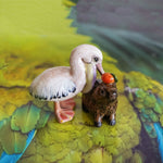 Pelican eating capybara figurine
