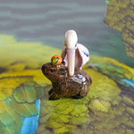 Pelican eating capybara figurine