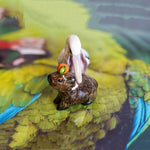 Pelican eating capybara figurine