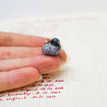 Pigeon with a lace pendant