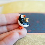 Puffin with a gold moon pendant