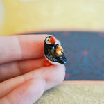 Puffin with a gold moon pendant