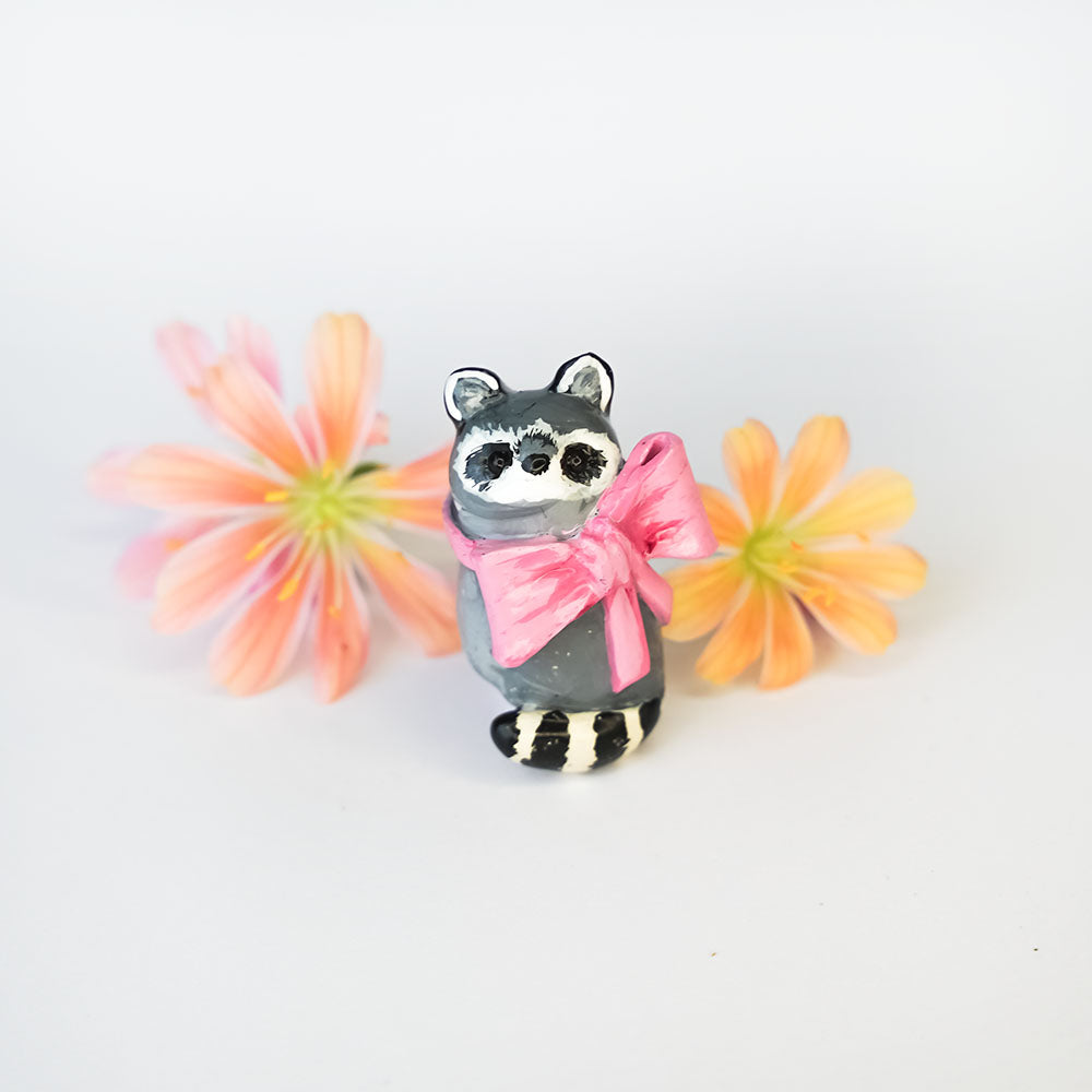 Racoon with a pink bow