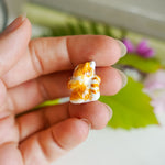 Maneki neko with a flower pendant