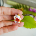 Maneki neko with a flower pendant