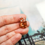 Red panda with a gold moon pendant