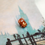 Red panda with a gold moon pendant