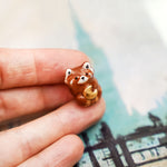 Red panda with a gold moon pendant