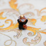 Red panda with a gold star pendant