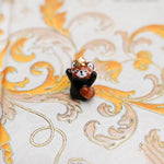 Red panda with a gold star pendant