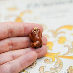 Red panda with a gold star pendant