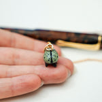 Rhinoceros beetle with a gold star pendant