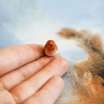 Robin with a lace pendant