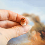 Robin with a lace pendant