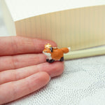 Running fox with a star pendant