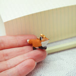 Running fox with a star pendant