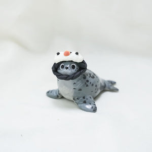 Seal with hats (penguin and shark) figurine
