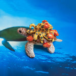 Green turtle with ringed octopus and school of fish figurine