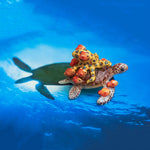 Green turtle with ringed octopus and school of fish figurine