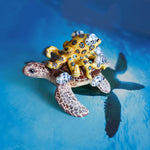 Green turtle with ringed octopus and school of fish figurine