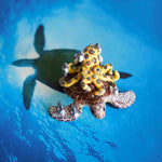 Green turtle with ringed octopus and school of fish figurine