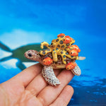 Green turtle with ringed octopus and school of fish figurine