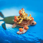 Green turtle with ringed octopus and school of fish figurine