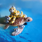Green turtle with ringed octopus and school of fish figurine