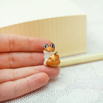 Sleeping fox with a star pendant