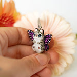 Snow leopard with butterfly wings pendant
