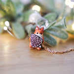 Squirrel with a gingerbread tree pendant