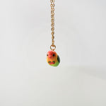 Lovebird with fruit pendant