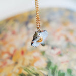 Sugar glider with a gold heart pendant