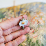 Sugar glider with a gold heart pendant