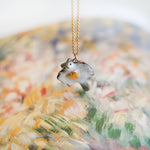 Sugar glider with a gold heart pendant