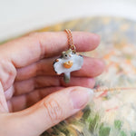 Sugar glider with a gold heart pendant