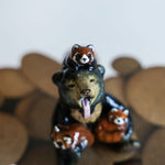 Sun bear with red pandas! figurine