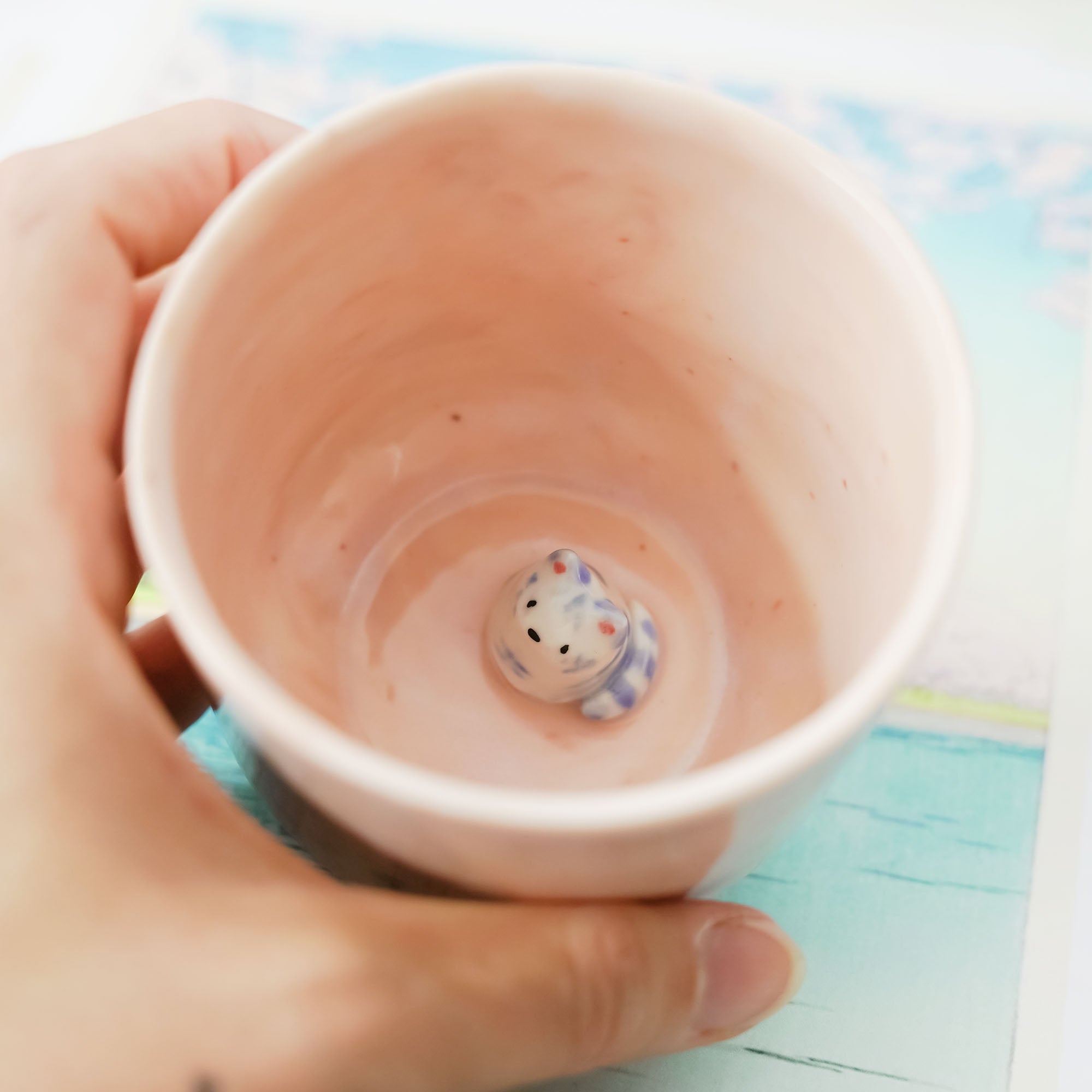 Pink porcelain cup with a blue tiger